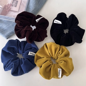 Set of 4 vintage velvet scrunchies in brown, black, navy, and yellow with labels