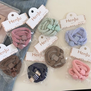 Detail of high-elasticity hair bands in pastel colors with geometric decorative charms