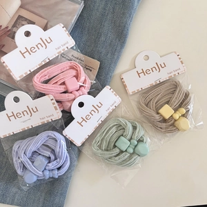 Detail view of high-elasticity hair bands in pastel colors with geometric charms