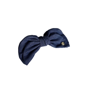 Vintage dark blue denim bow hair clip with elegant golden metal logo tag detail