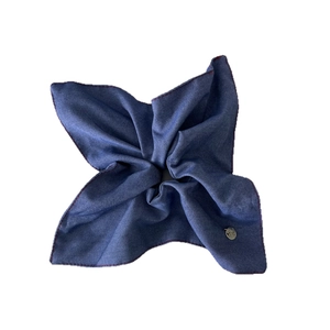 Vintage denim blue scrunchie with red stitching and silver metal tag on white background
