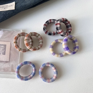 Detailed view of colorful plaid seamless elastic hair ties with woven knit texture