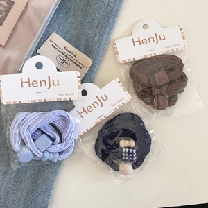 Detailed set of elastic hair bands with acrylic beads and bows on denim background