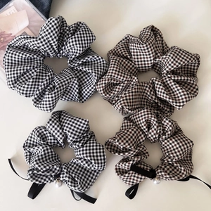 Set of four checkered scrunchies featuring retro patterns and elegant pearl charms