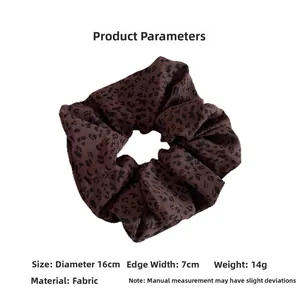 Detail view showing 16cm leopard print oversized scrunchie dimensions and soft fabric texture