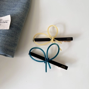 Handmade acetate bow hair clips in yellow and dark blue with gold metal duckbill grip