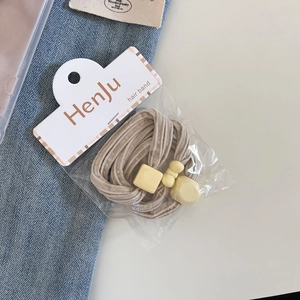 Three-piece set of beige high-elasticity hair bands with yellow charms in retail packaging