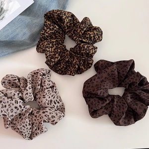 Three vintage leopard print scrunchies set for hair ties on a clean white background