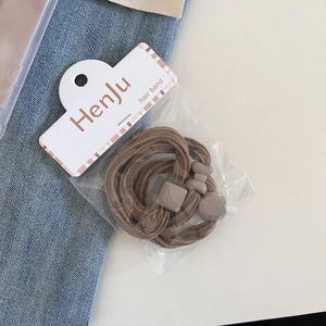 Detail of high-elasticity hair bands in coffee brown tones with decorative beads