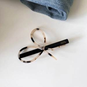 Detail showing the gold France Handmade stamp on a tortoiseshell bow hair clip