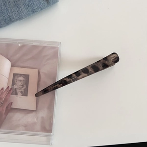 Dettaglio della clip per capelli lucida con motivo leopardato e molla in metallo