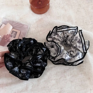 Detailed view of ink wash tie-dye scrunchies with elegant four-layer lock-stitched edges