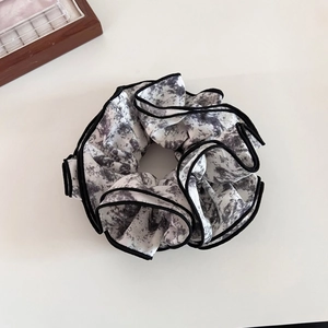 Elegant black and white ink marble pattern scrunchie with detailed black edge stitching