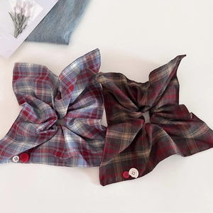 Red and blue plaid scrunchie with button details and vintage fabric texture