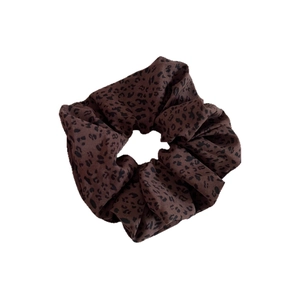 Vintage leopard print scrunchie with ribbed texture for retro ponytail and bun styling