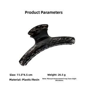 Detail view of large leopard print hair claw clip with black and grey marble texture
