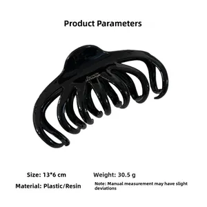 Detail view of large black French shark hair clip showing 13x6cm dimensions and weight