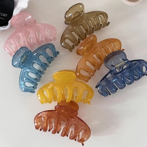 Macro detail of high-quality jelly color hair claws in various translucent resin finishes