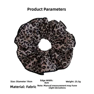 Detail showing oversized leopard print scrunchie dimensions 19cm diameter and fabric texture