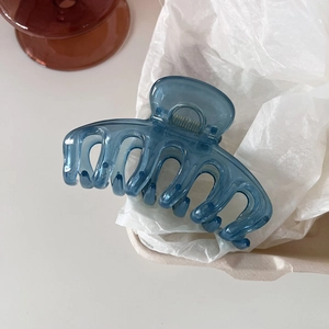 Minimalist jelly blue large claw clip with metal spring on a soft white background