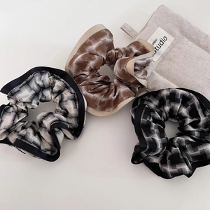 Three Korean-style plaid scrunchies in black and brown with smooth satin-trimmed edges