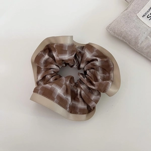 Elegant brown plaid scrunchie with silk edge decoration for stylish hair styling