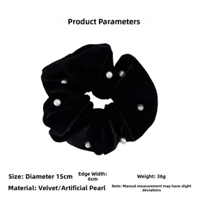 Detailed close-up of premium black velvet scrunchie featuring elegant white faux pearls