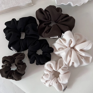Detail of 6-piece corduroy hair scrunchie set in black, coffee, and beige colors