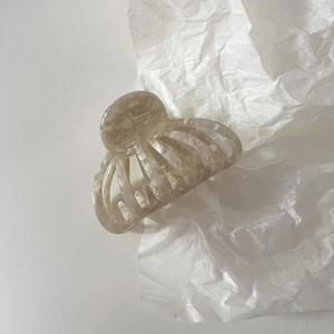Detail view of medium cream acetate shell hair claw with vintage marble texture pattern