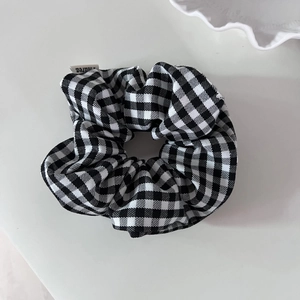 Vintage black and white plaid scrunchie with classic checkered pattern and white fabric tag