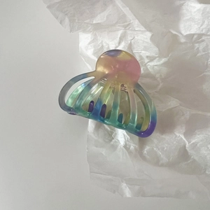 Macro detail of medium acetate shell claw clip with iridescent colorful gradient finish