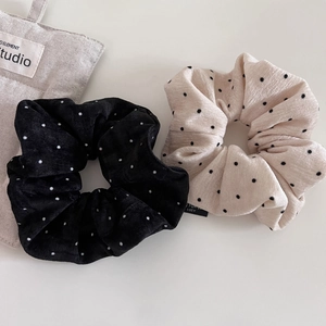 Plush polka dot scrunchie set in black and cream velvet for minimalist hair styling