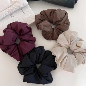 Detailed set of four puffy scrunchies in burgundy, coffee, black, and beige colors