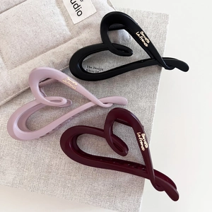 Matte heart-shaped hair claw clips set in black, rose pink, and burgundy finish