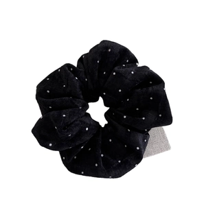 Soft black plush scrunchie with white polka dots for elegant low ponytail hairstyles