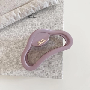 Detail of matte purple cloud-shaped hair claw clip with golden Barrette La France text
