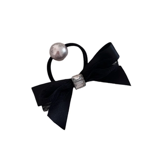 Elegant black bow hair tie with rhinestone crystals and silver bead on white background
