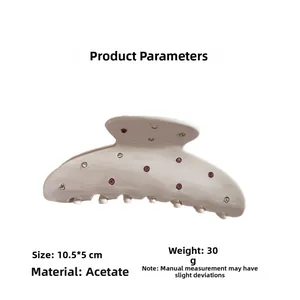 Macro detail of cream acetate hair claw clip with colorful rhinestones 10.5x5cm