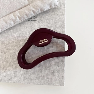 Detailed close-up of matte dark red hair claw clip featuring golden Barrette La France logo
