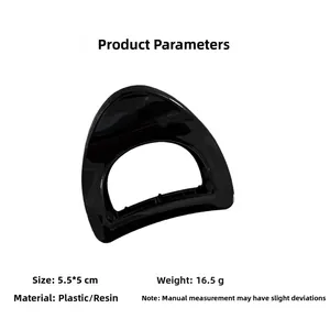 Detail view of a black geometric hair claw with glossy resin finish and 5.5cm size