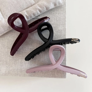 Set of three matte vintage hair claws in burgundy, black and pink with gold lettering