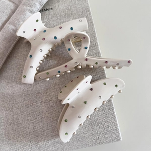 Detailed set of cream resin hair claws with colorful rhinestones in three geometric styles
