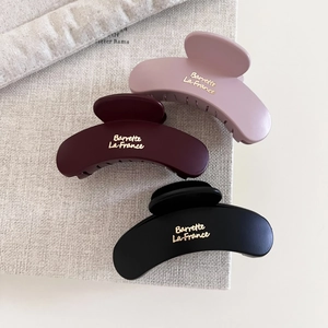 Matte burgundy, pink, and black crescent hair claws with gold Barrette La France text
