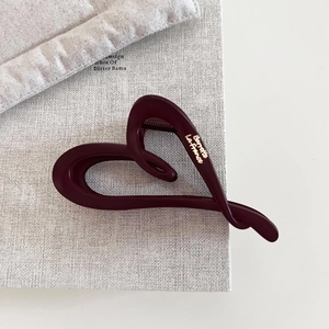 Detail of matte burgundy heart hair claw with golden Barrette La France lettering