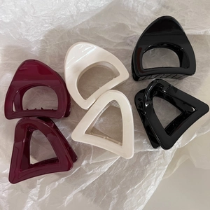 Minimalist geometric triangle and D-shaped hair claws in wine red, cream, and black colors