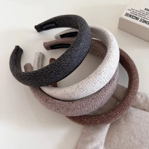 Detailed texture of thick knitted sponge headbands featuring handmade fabric labels