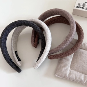 Minimalist wool sponge headbands in neutral tones with thick knit texture and handmade label