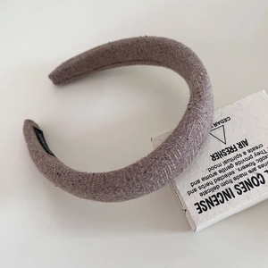 Detail of wool fabric headband with herringbone texture and handmade label