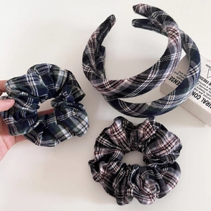 Detailed view of vintage tartan headband and plaid scrunchies with soft woven texture