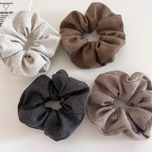 Set of four autumn winter oatmeal wool textured scrunchies with herringbone pattern